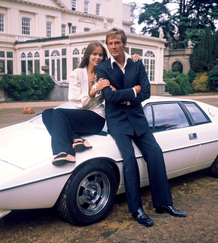 Barbara Bach and Roger Moore, stars of the James Bond film The Spy Who Loved Me leaning on the famous amphibious Lotus Esprit in 1977. (Photo by Hulton Archive/Getty Images)